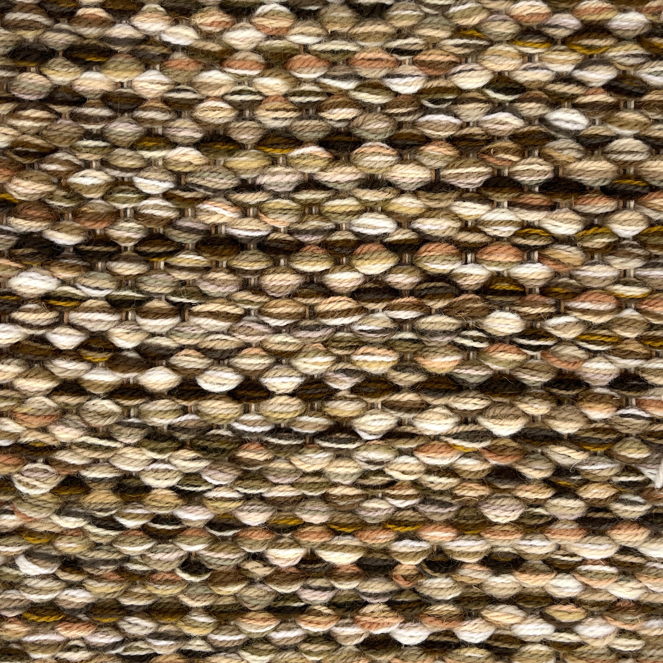 Textured handwoven rug with a strié pattern in brown and beige. 