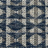 Close-up of a woven rug with geometric pattern in shades of blue.