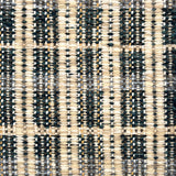 Close-up of a textured teal, cream and beige plaid woven rug. 