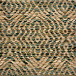 Textured handwoven rug with a diamond pattern in tan and green.