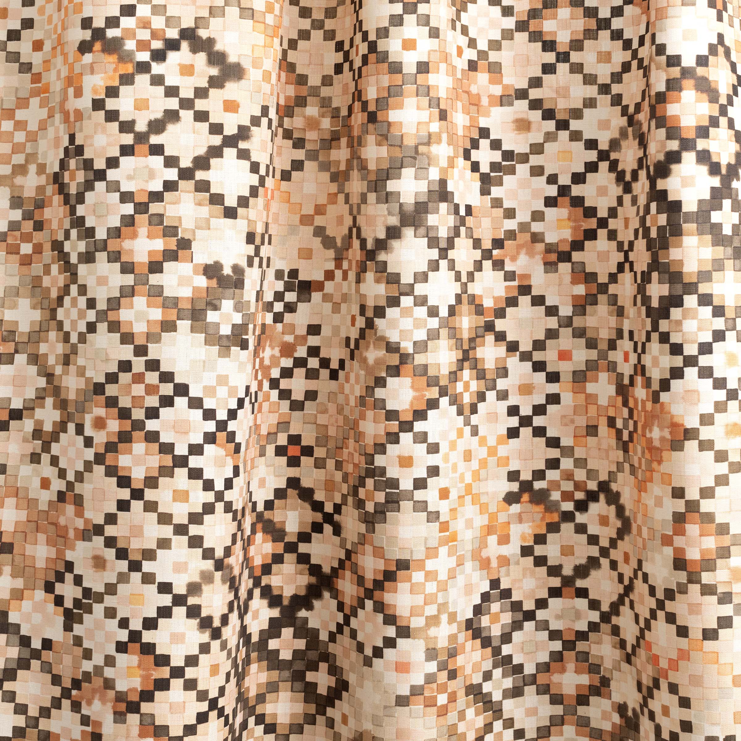 Draped fabric yardage in a painterly small-scale diamond print in shades of cream, brown and orange.