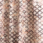 Draped fabric yardage in a painterly small-scale diamond print in shades of cream, brown, purple and pink.