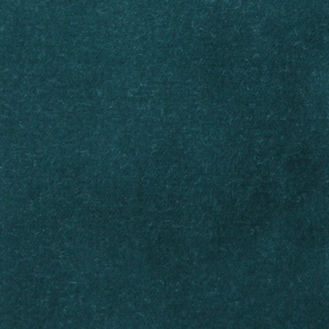 Detail of velvet fabric yardage in teal.