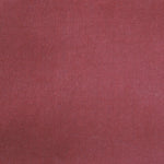 Detail of velvet fabric yardage in dusty red.