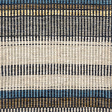 Handwoven rug detail in a stripe design in blue, yellow, tan, cream, and grey