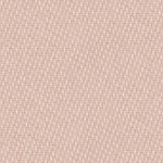 Detail of fabric in a small-scale dot and dash pattern in shades of cream and pink on a light pink field.