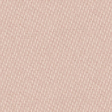 Detail of fabric in a small-scale dot and dash pattern in shades of cream and pink on a light pink field.