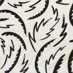 Linen fabric with a playful brushstroke print in black on a natural field.