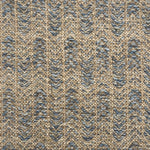 Handwoven rug detail in a herringbone design in blue and tan