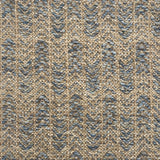 Handwoven rug detail in a herringbone design in blue and tan