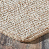 Beige woven rug on a wooden floor