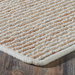Textured beige rug on a wooden floor