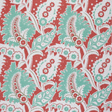 Detail of fabric in a botanical paisley print in shades of white, turquoise and green on a red field.