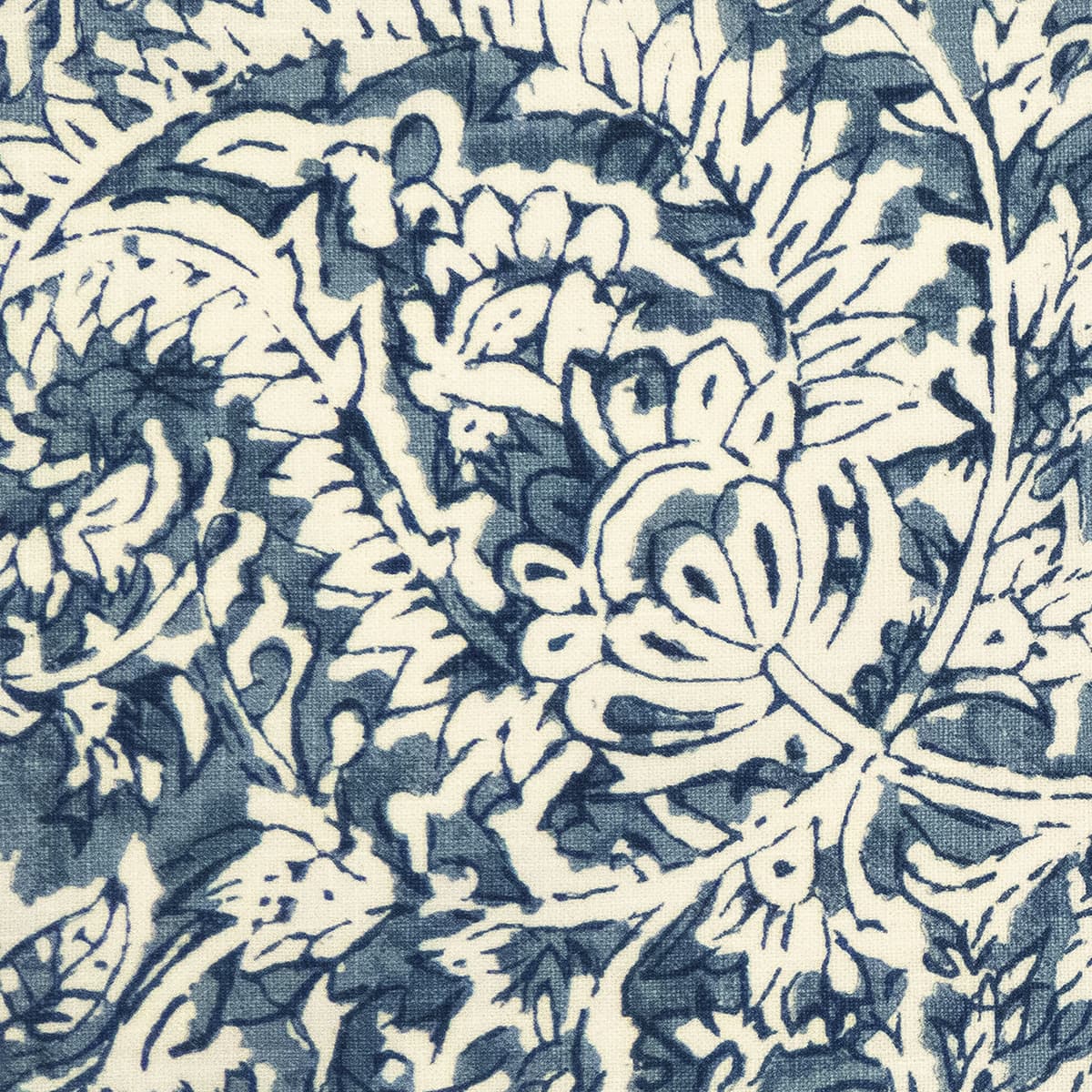 Detail of fabric in a floral paisley print shades of blue and navy on a cream field.