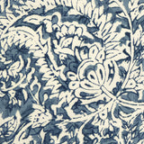 Detail of fabric in a floral paisley print shades of blue and navy on a cream field.