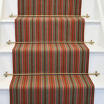 Striped flatweave runner in red grey and pink on white staircase