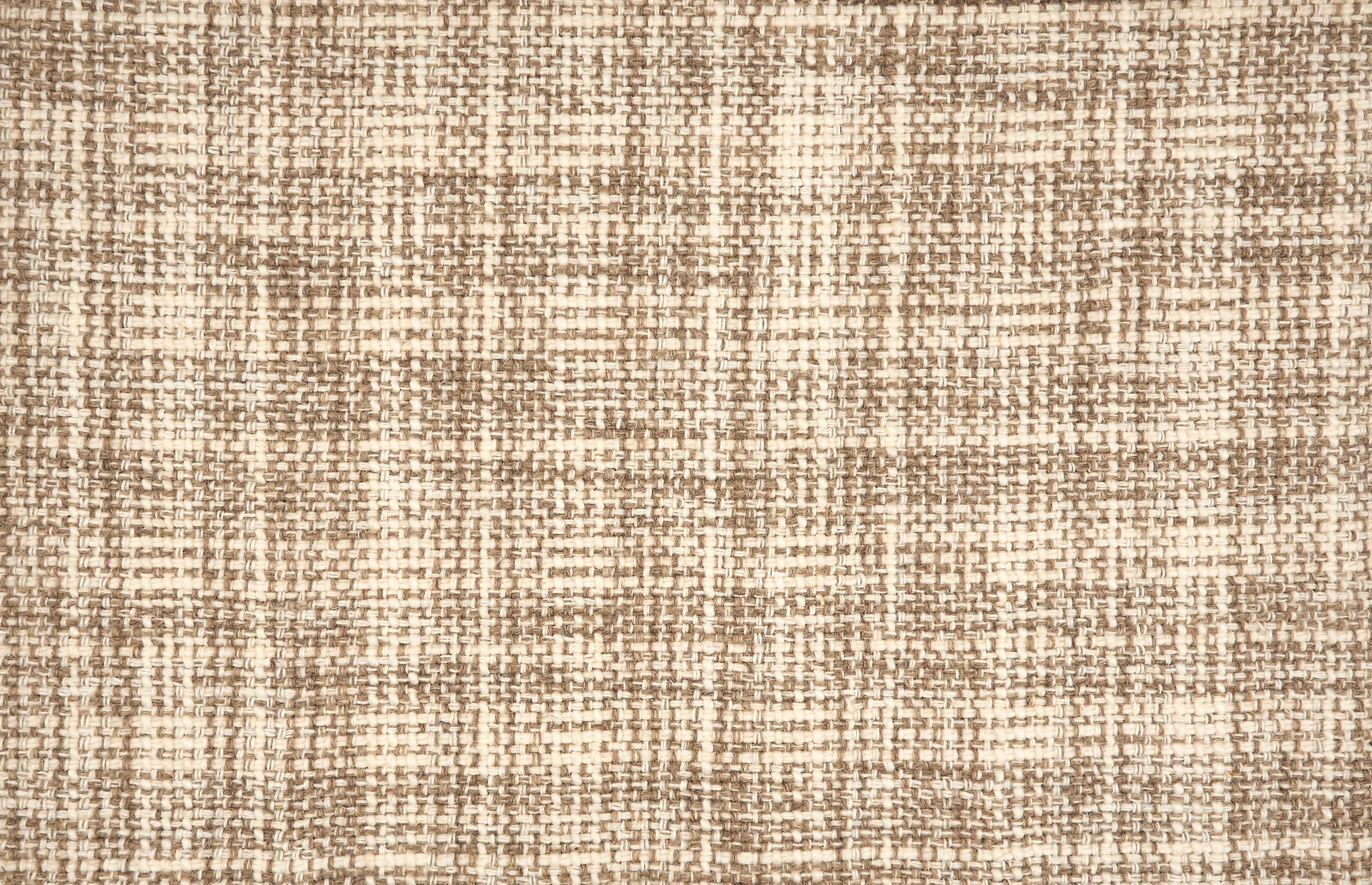 Broadloom carpet in a strié basketweave pattern in cream and brown.