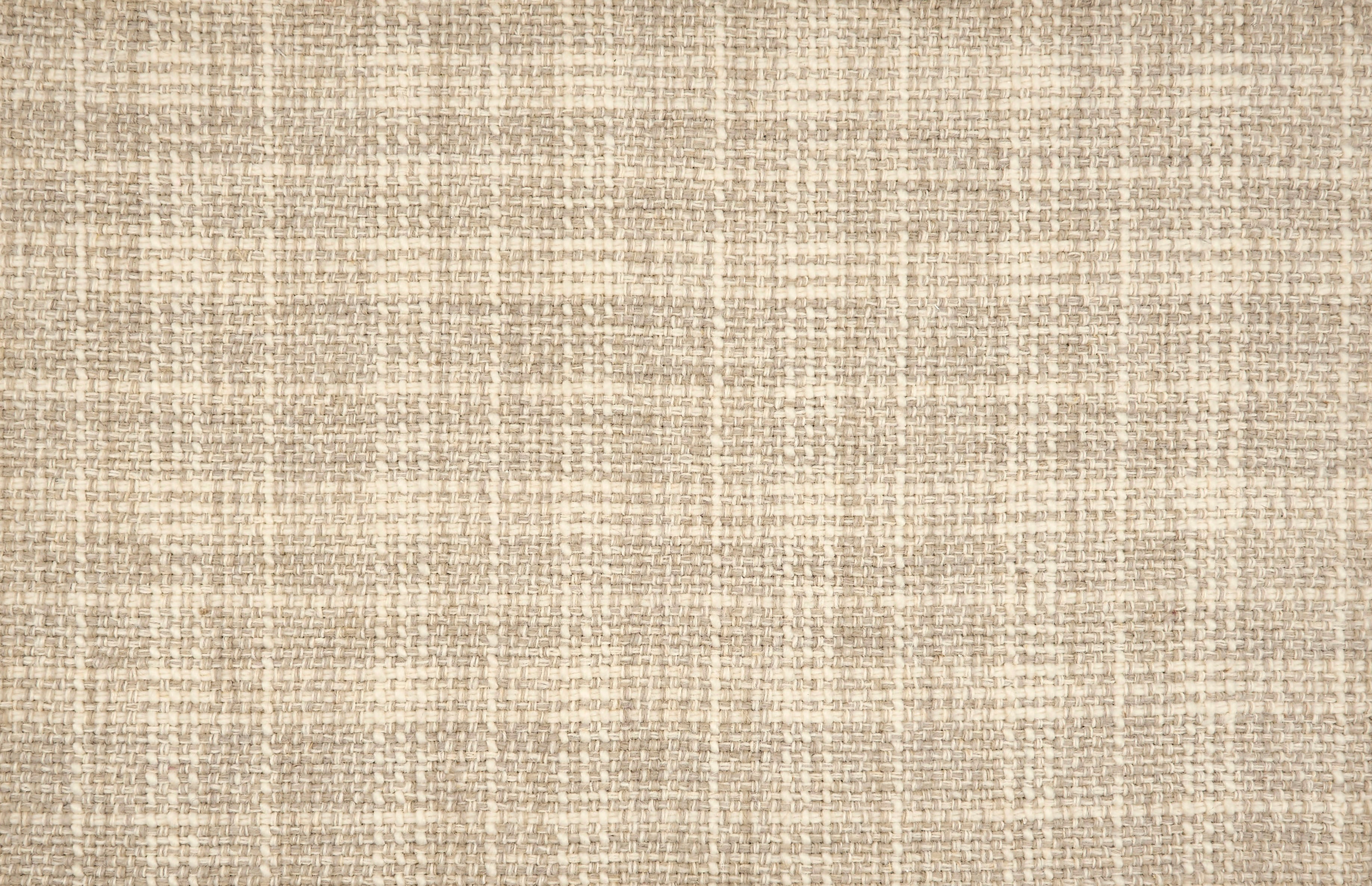 Broadloom carpet in a strié basketweave pattern in cream and taupe.