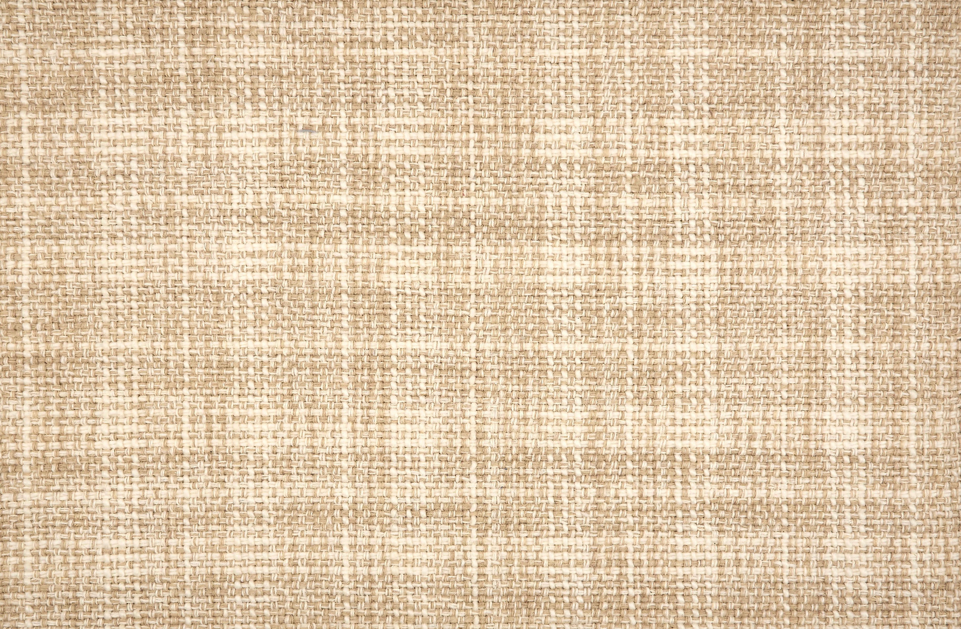 Broadloom carpet in a strié basketweave pattern in cream and tan.