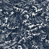 Detail of fabric in a playful wave print in white on a navy watercolor field.
