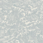 Detail of fabric in a playful wave print in white on a light blue watercolor field.