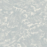 Detail of fabric in a playful wave print in white on a light blue watercolor field.