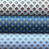 Three wallpaper rolls with dainy floral patterns. 