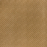 printed linen fabric in a clustered dot pattern in cream on a camel field.