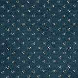 Detail of a linen fabric in a clustered dot pattern in cream on an indigo field.