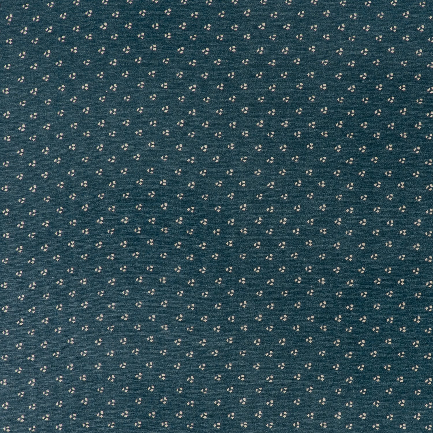 printed linen fabric in a clustered dot pattern in cream on an indigo field.