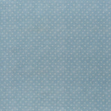 printed linen fabric in a clustered dot pattern in cream on a sky blue field.