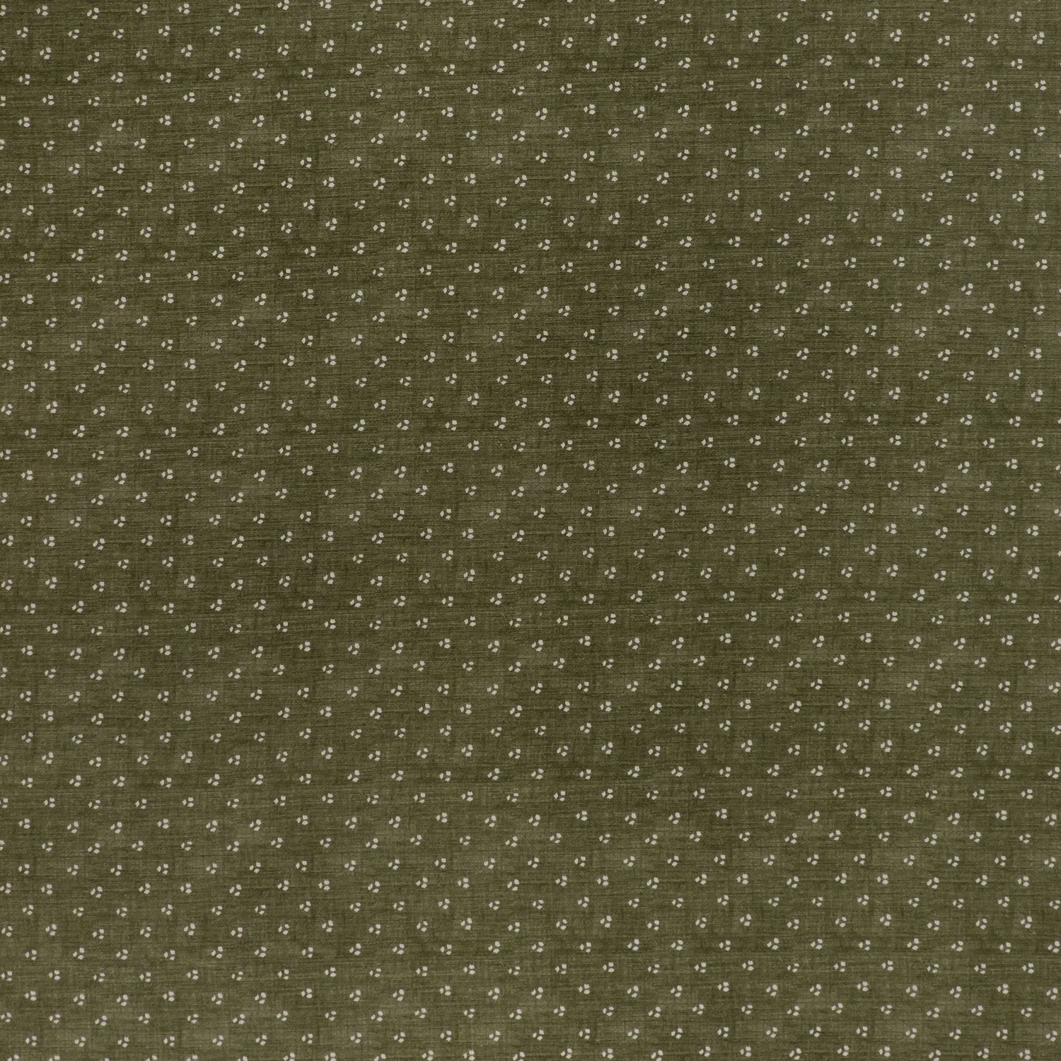 printed linen fabric in a clustered dot pattern in cream on a moss field.