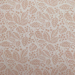 Detail of wallpaper in a repeating leaf print in cream on a white field.