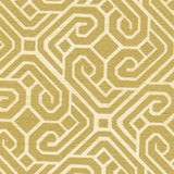 Detail of fabric in a geometric lattice print in gold on a cream field.