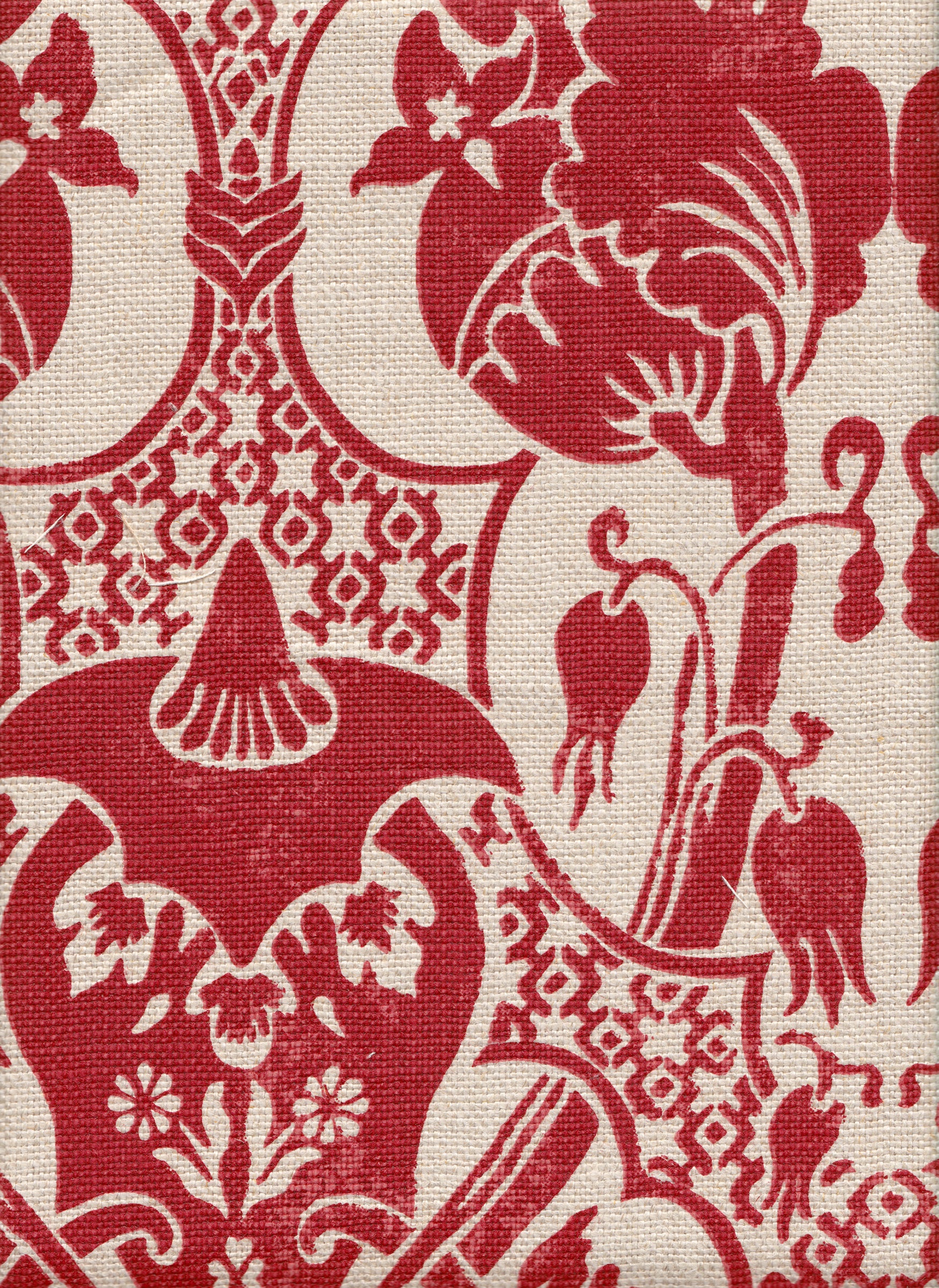 Detail of fabric in a damask vase print in red on a cream field.