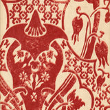 Detail of wallpaper in a damask vase print in red on a cream field.