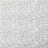 Detail of fabric in a dense paisley print in white on a mottled gray field.