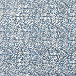 Detail of fabric in a dense paisley print in white on a mottled navy field.