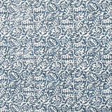 Detail of fabric in a dense paisley print in white on a mottled navy field.