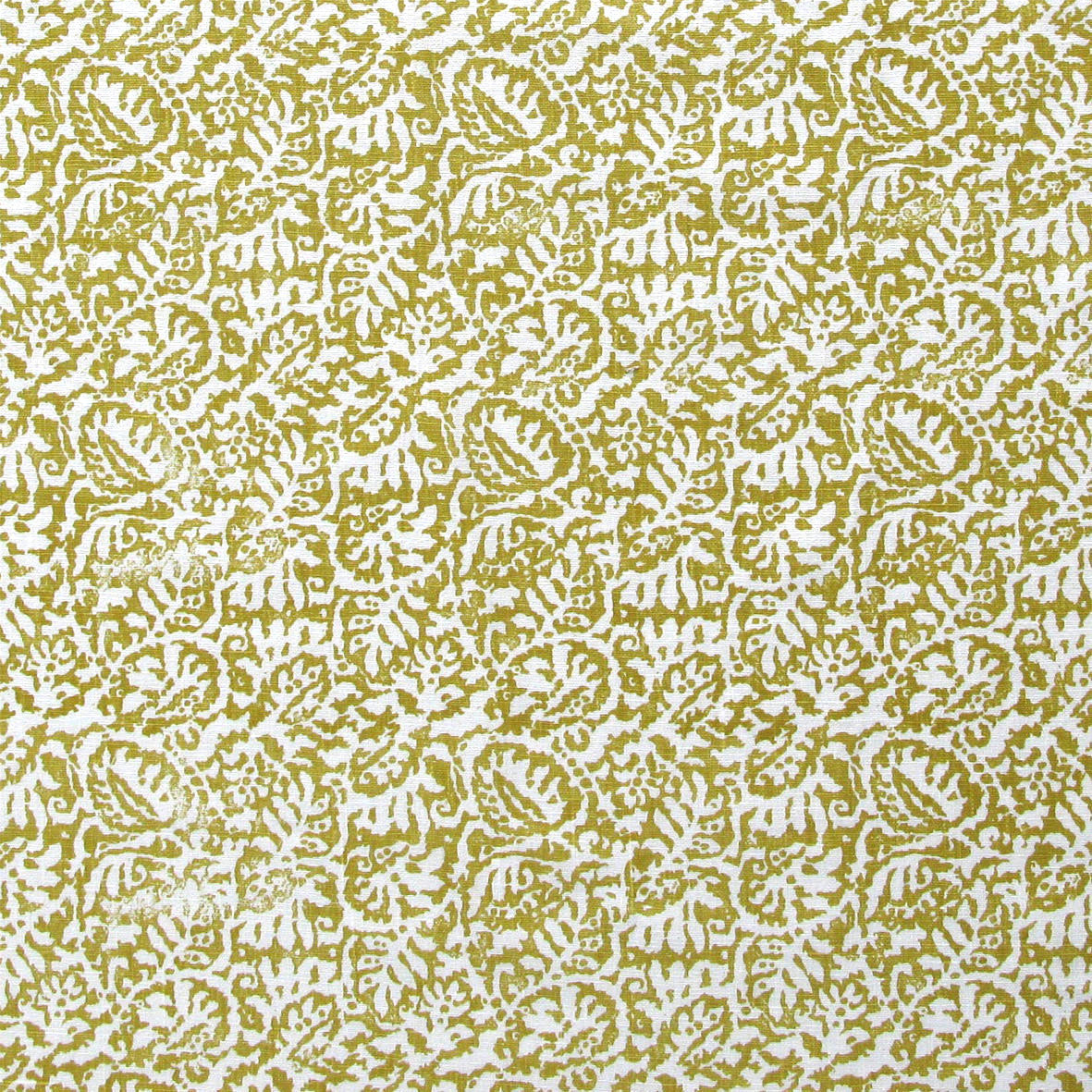 Detail of fabric in a dense paisley print in white on an olive field.