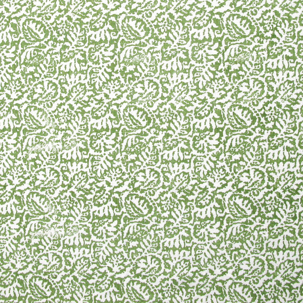 Detail of fabric in a dense paisley print in white on a green field.