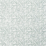 Detail of fabric in a dense paisley print in white on a gray-blue field.