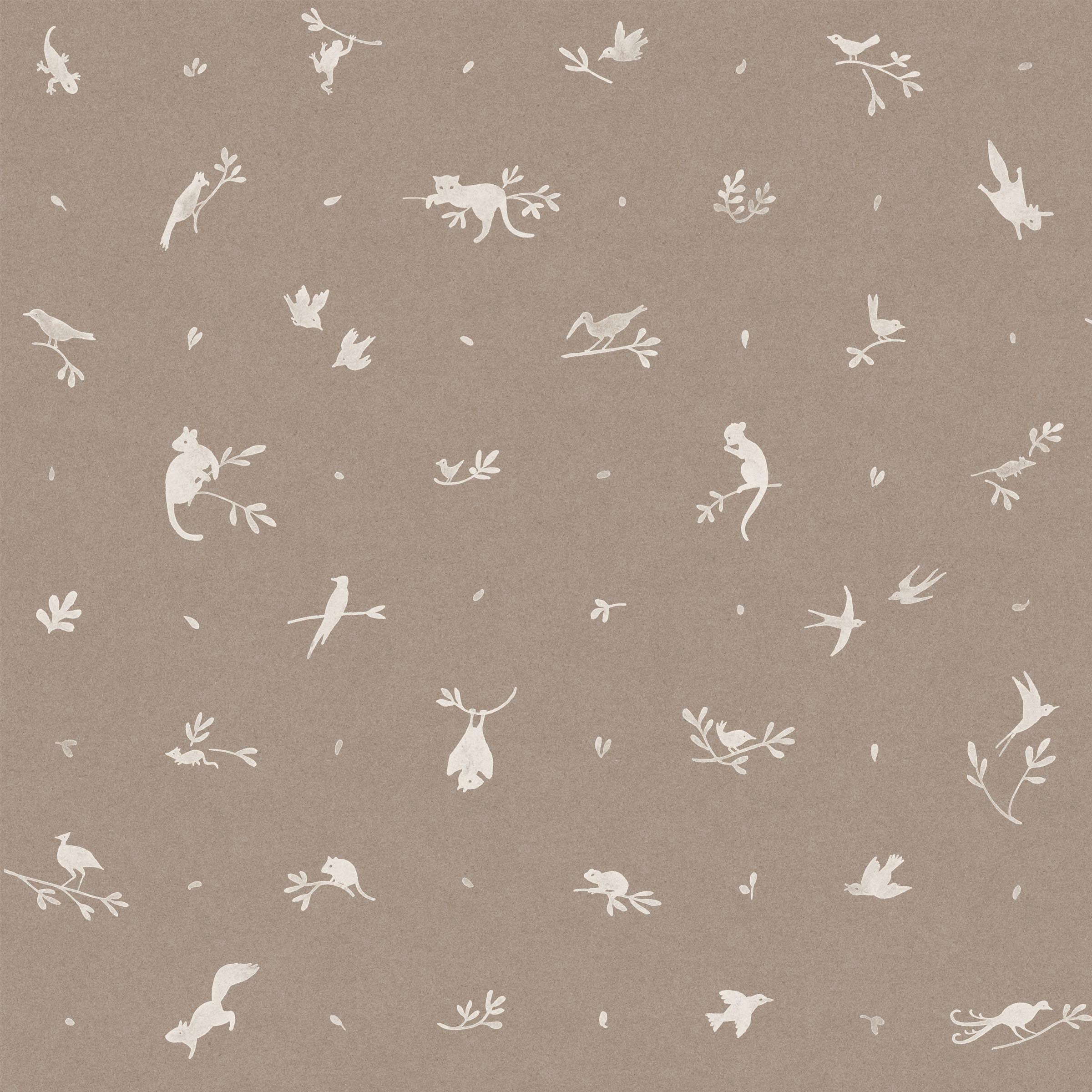 Detail of fabric in a playful animal and branch print in cream on a brown field.