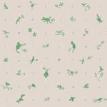 Detail of fabric in a playful animal and branch print in green on a tan field.