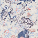 Detail of wallpaper in an animal and tree branch print in shades of blue, gray and red on a cream field.