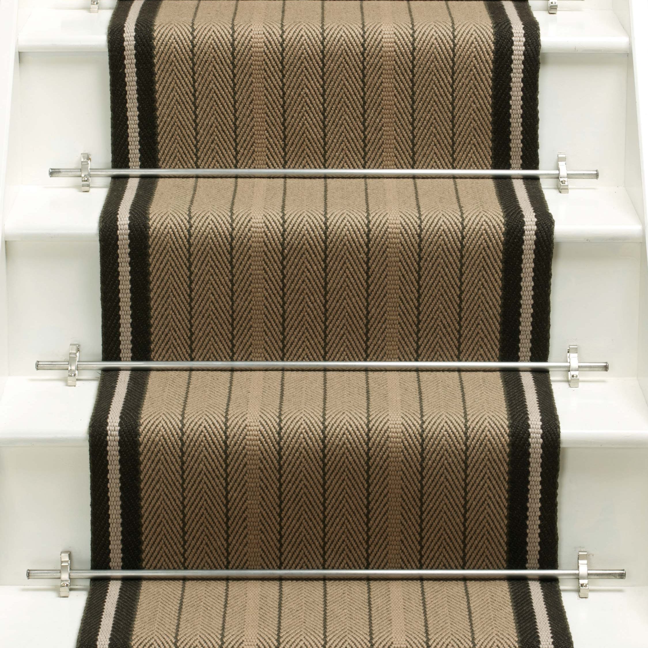 Striped flatweave runner in tan and black on white staircase