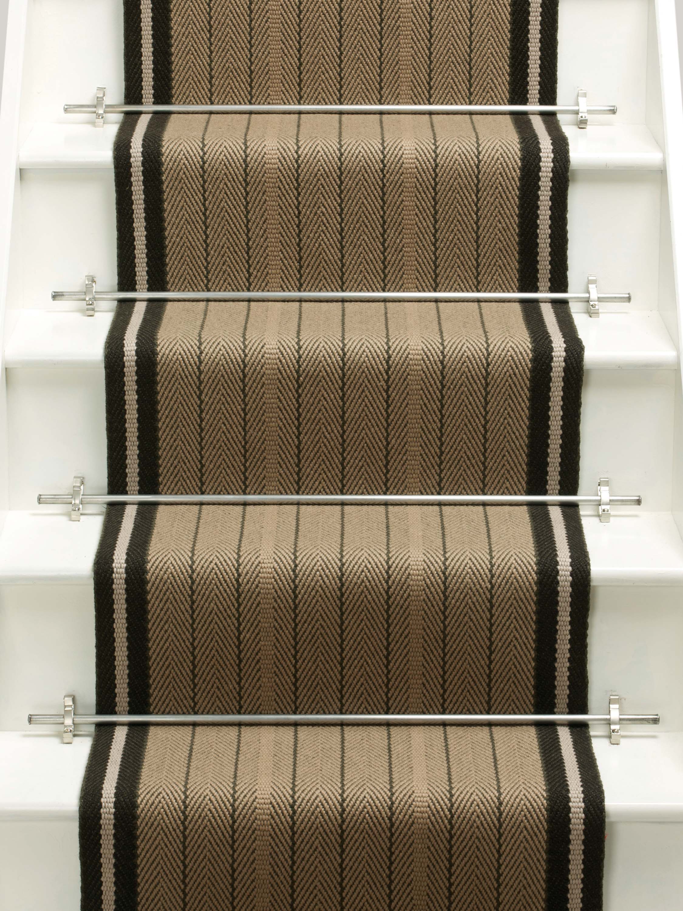 Striped flatweave runner in tan and black on white staircase