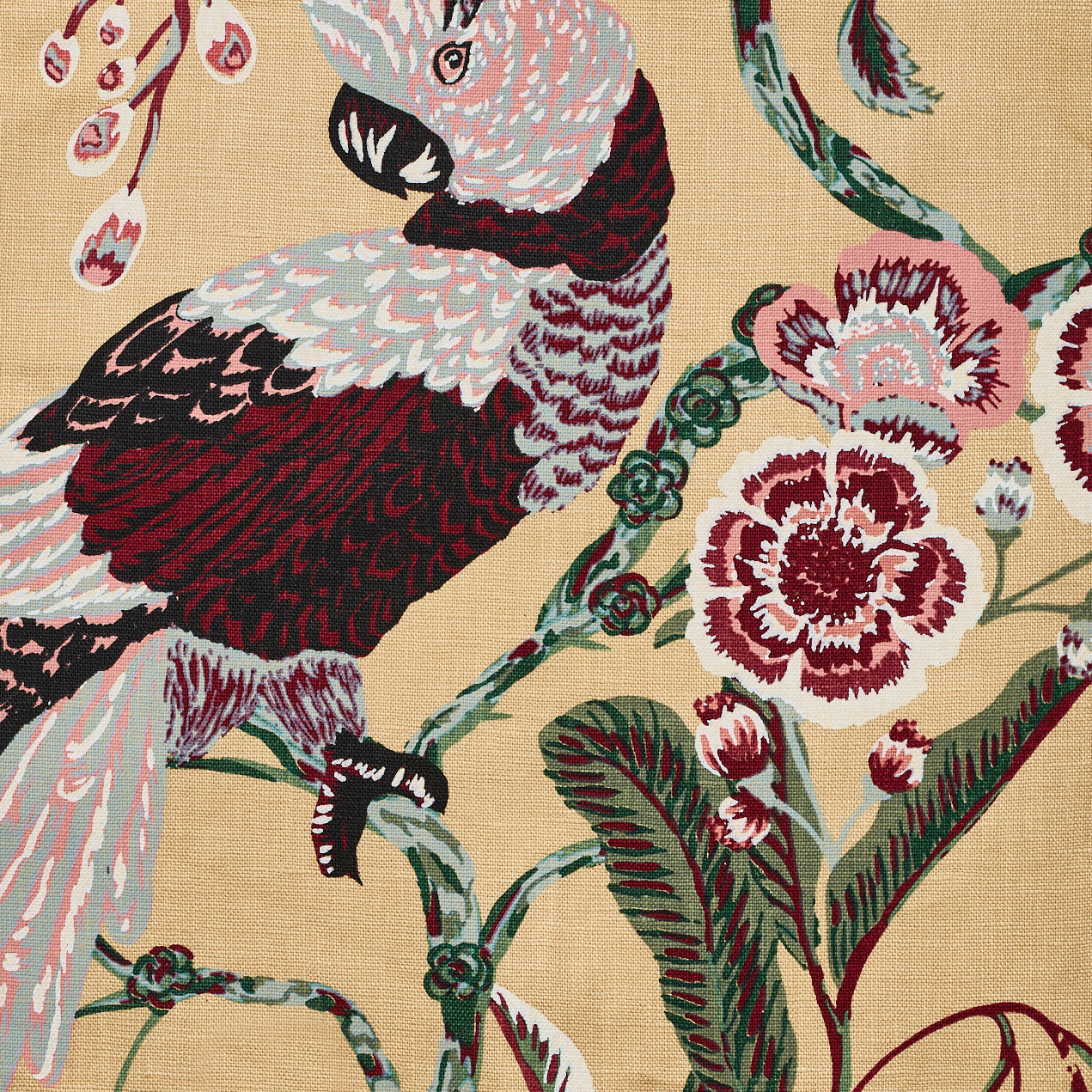 Detail of fabric in a large-scale botanical and bird print in shades of green, red and pink on a tan field.