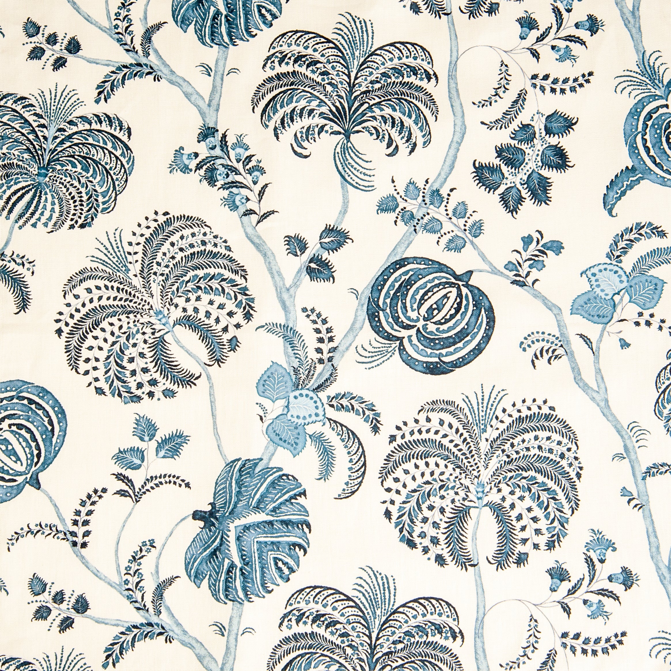 Detail of fabric in a floral paisley in shades of blue and navy on a cream field.