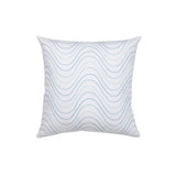 Square throw pillow with an undulating embroidery pattern in shades of blue on a white field.